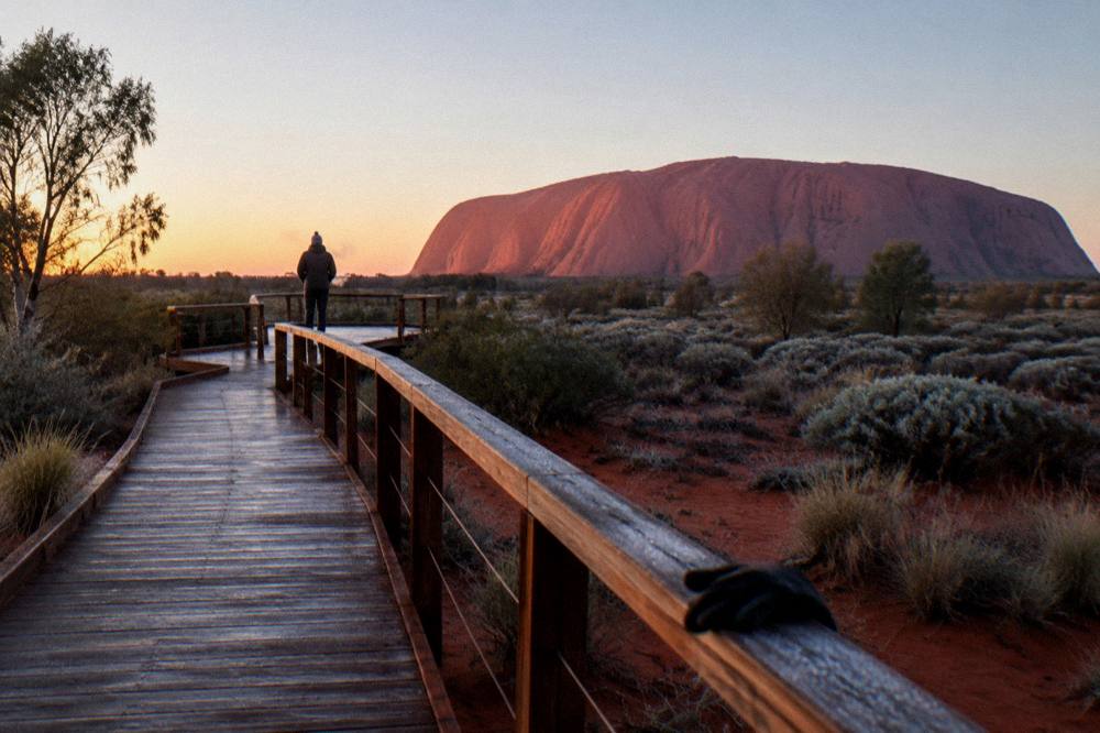 Desert landscape at first light with a boardwalk leading toward a viewing platform